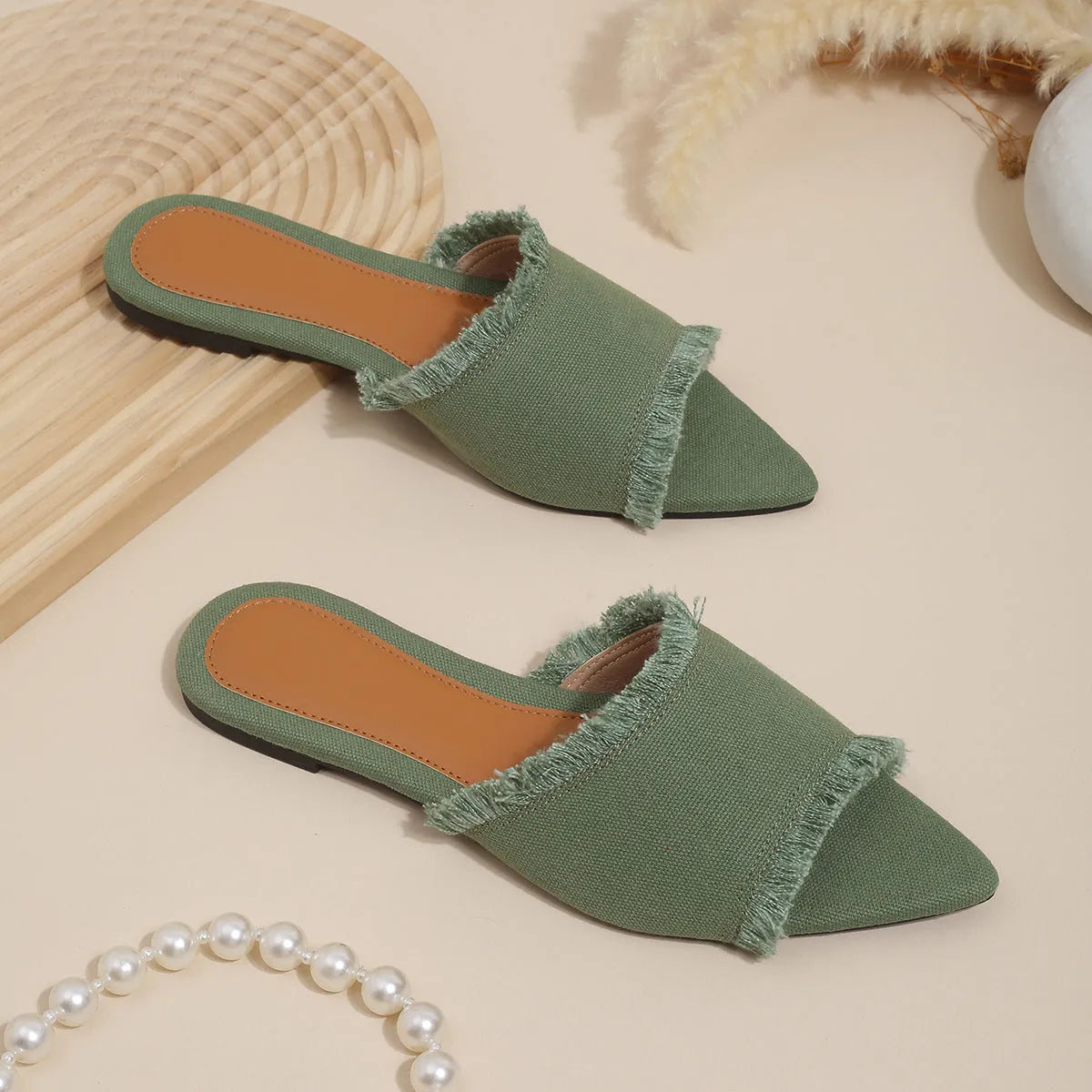 Women's denim flat slippers with tassel detail in multiple colour options showing leather lining and PVC sole