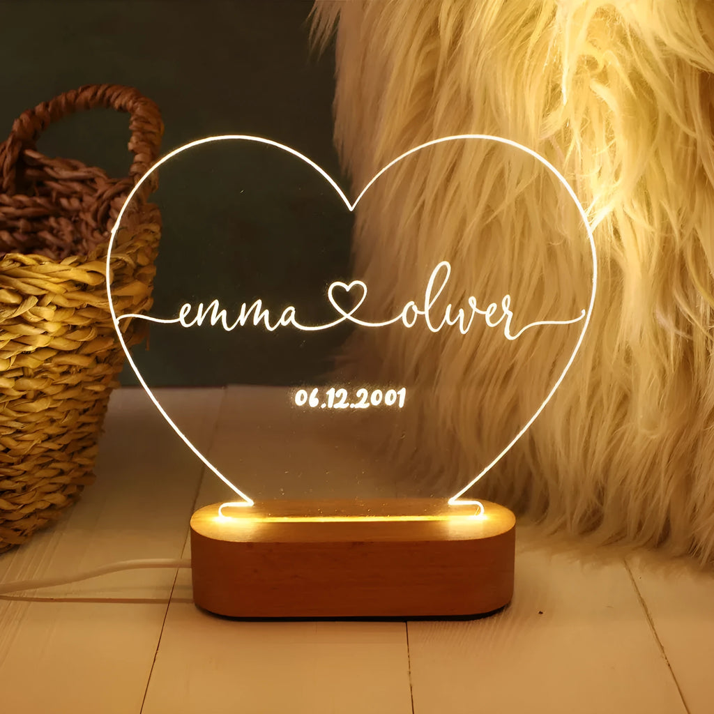 Custom transparent acrylic night light engraved with names, lit by LED base, dimensions 20cm by 11.5cm.