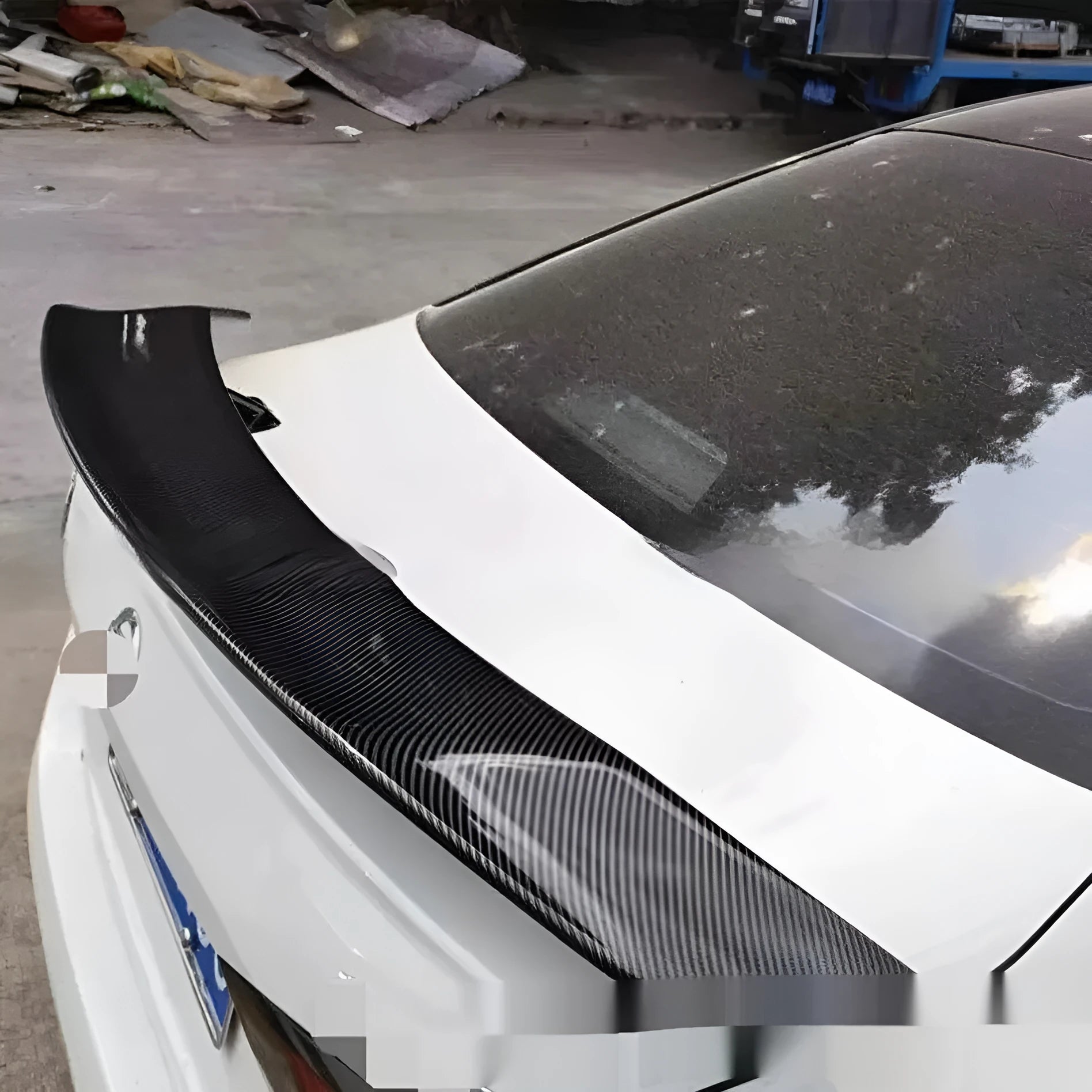 Punch-free adhesive mount car spoiler in ABS plastic, shown in carbon pattern finish.