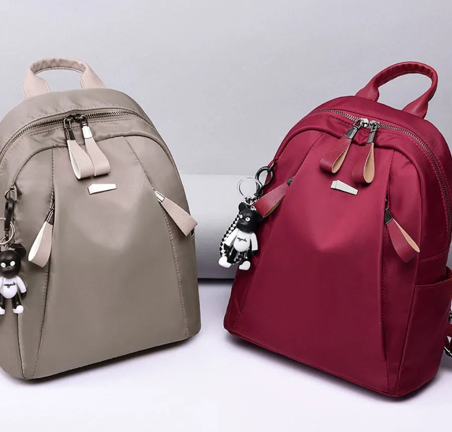 Medium Oxford cloth rucksack showing internal phone and ID compartments with dual straps