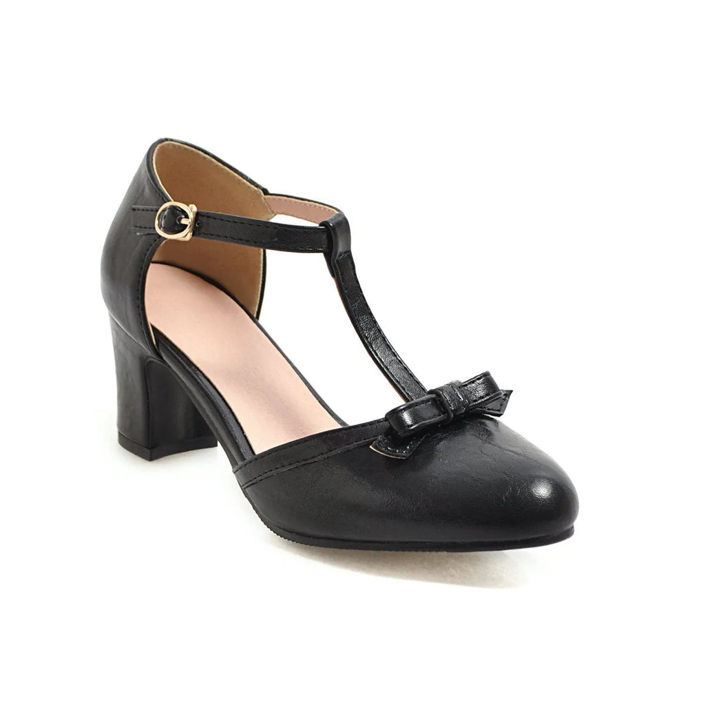 Yellow women's sandals with a chunky 6.5cm heel, bow tie detail, and buckle strap on a round toe.