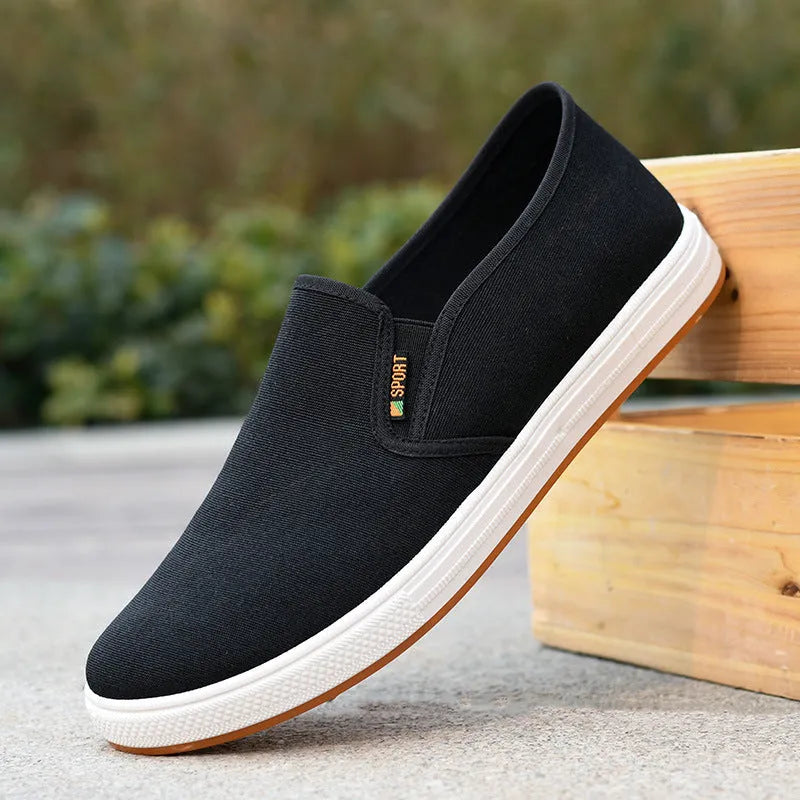 Men's black slip-on canvas shoes with round toe and composite sole