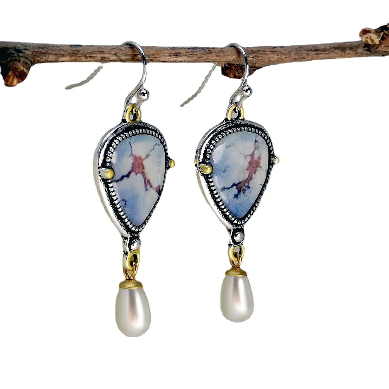 Retro blue geometric drop earrings with synthetic opal and pearl details on a two-tone electroplated metal setting.