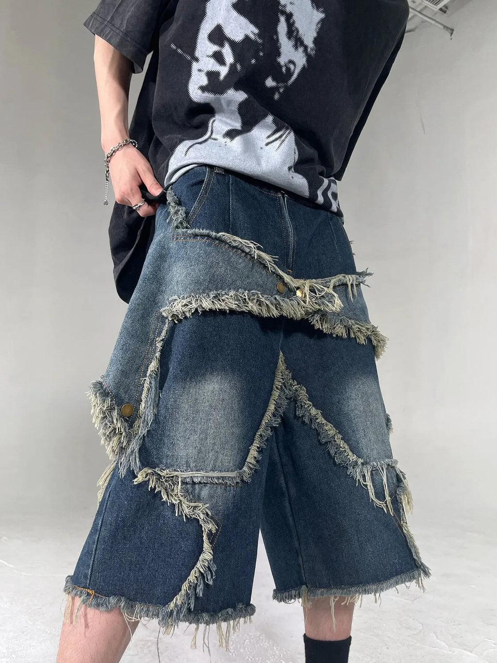 Blue denim shorts with five-pointed star detailing and frayed edges in loose fit style