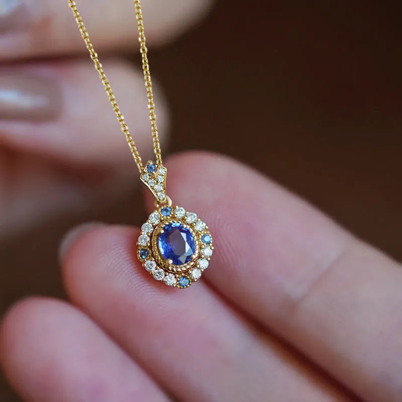 Golden women's necklace with mixed gem inlaid pendant on an adjustable copper box chain.