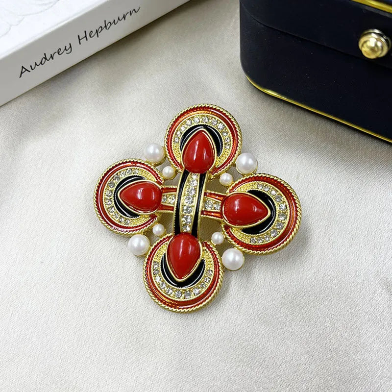 Close-up of vintage medieval baroque cross brooch with crystal details on zinc alloy base