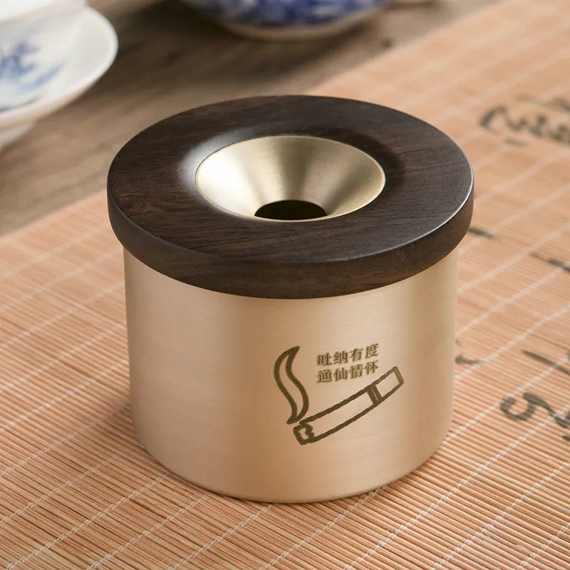 Brass ashtray with wooden lid in copper construction showing centre hole design