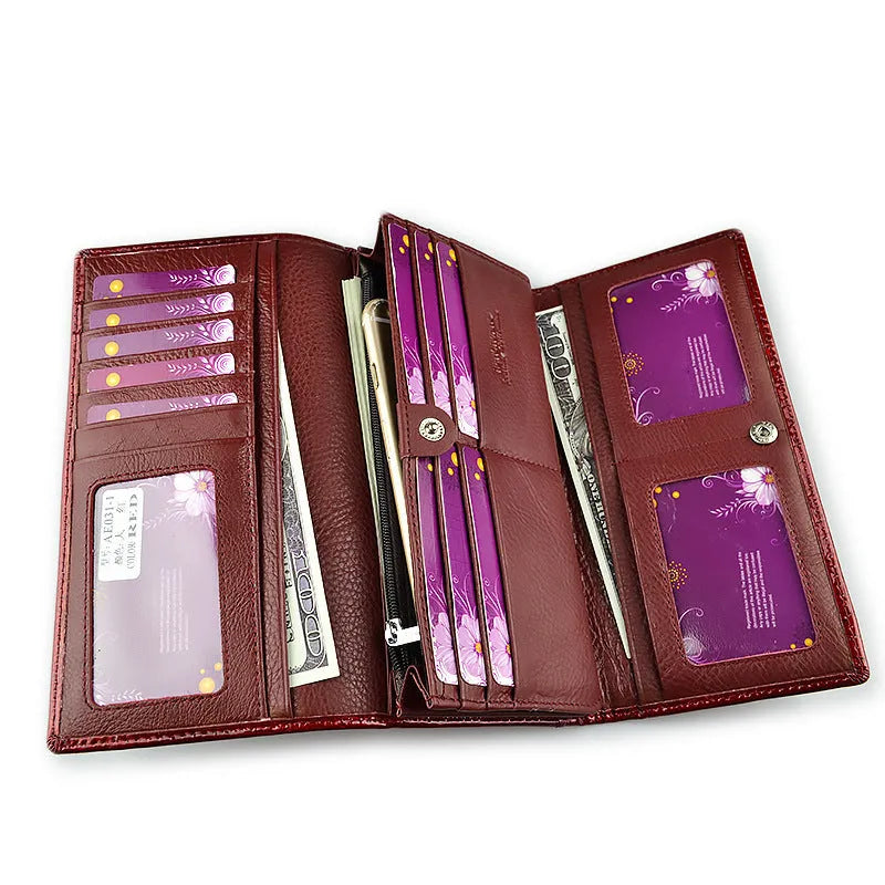 Wine red women's leather coin purse with a shiny crocodile pattern texture and open interior.