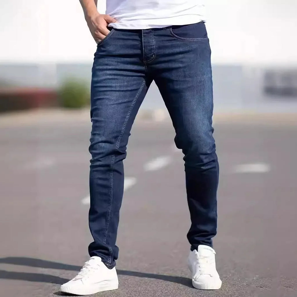 Men's dark blue slim fit jeans with skinny leg design and mid waist cut