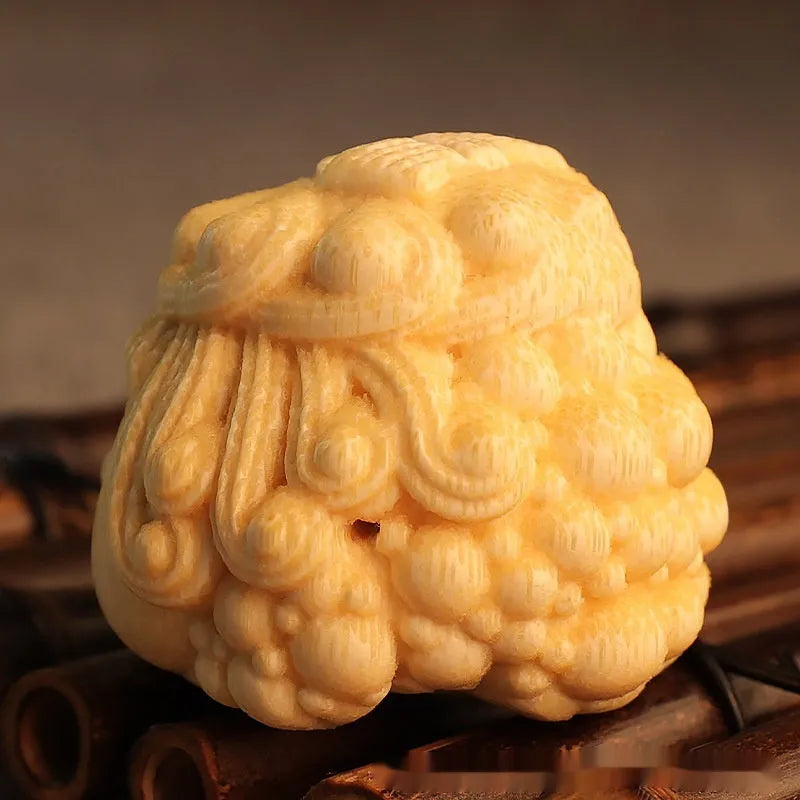 Solid bamboo golden toad princess ornament on a surface