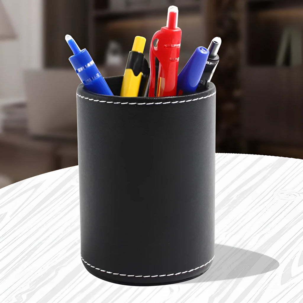 Round black leather pen holder on a desk