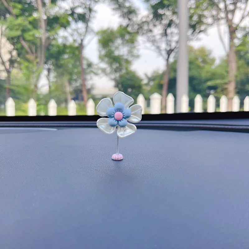 Small plastic swing decoration for car dashboard measuring 50mm by 35mm in multiple colours