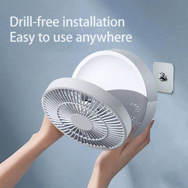 White portable USB rechargeable folding desk fan with remote control on wooden surface