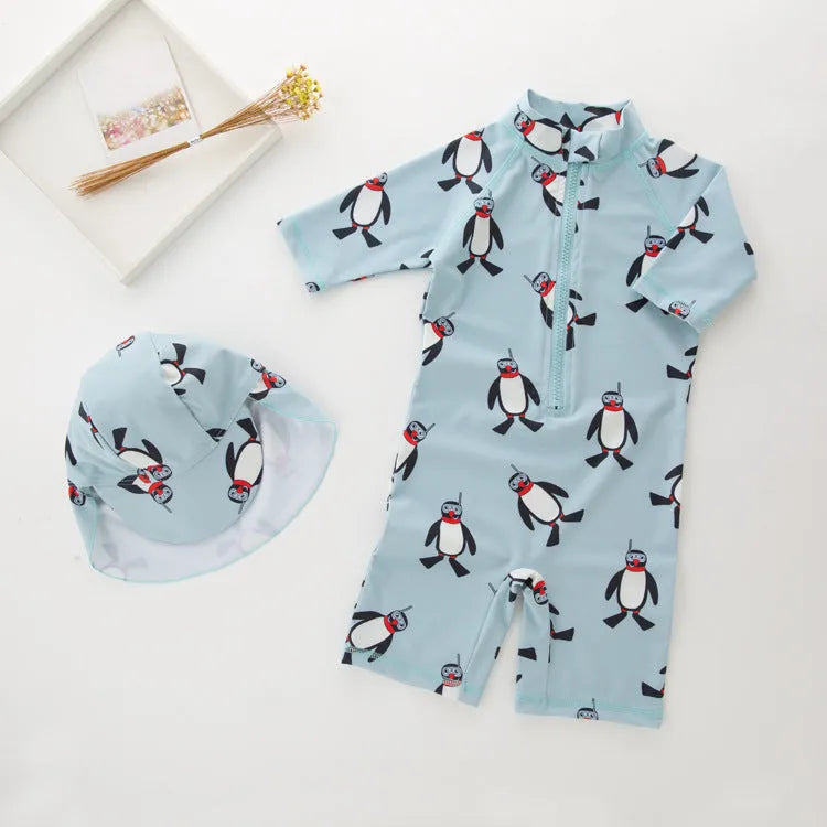 Blue boys two-piece penguin swimsuit with long sleeves and a matching swim cap.