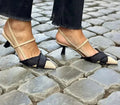 Apricot and black colour-block women's stiletto sandals with a pointed toe and ankle buckle.