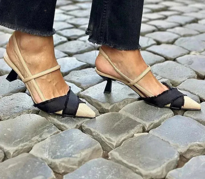 Apricot and black colour-block women's stiletto sandals with a pointed toe and ankle buckle.