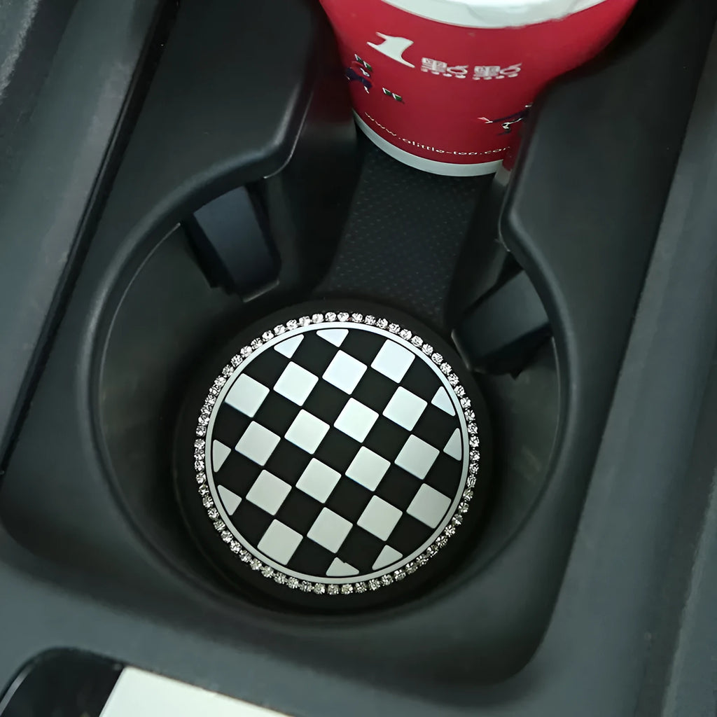 Black and white checkerboard pattern PVC car cup holder mat inserted in a vehicle centre console.