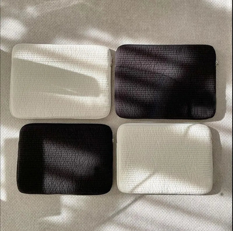 Black and white cotton cloth clutch-style laptop bag for tablets, showing internal coin pocket.