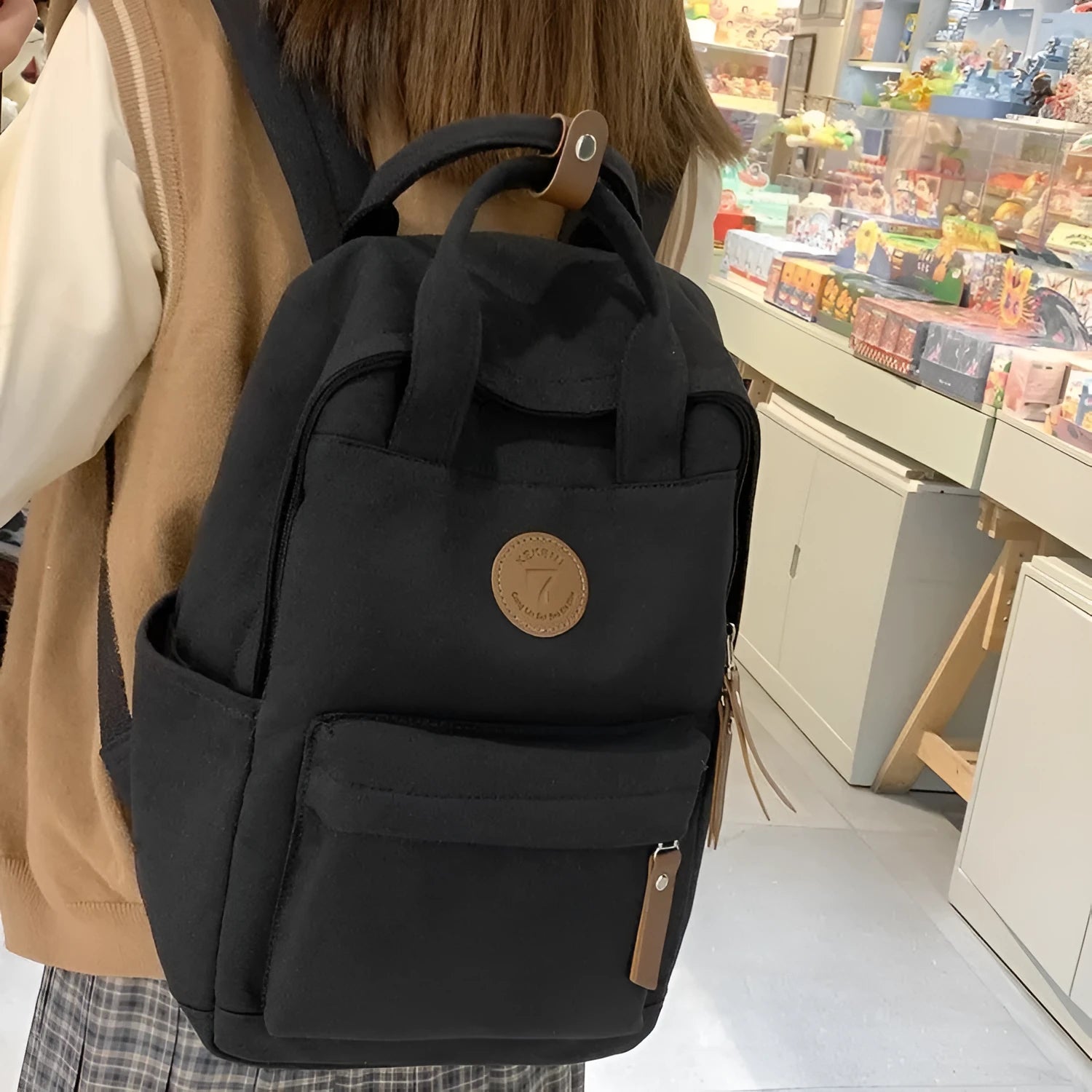Black Oxford cloth backpack with curved shoulder straps for school and travel use
