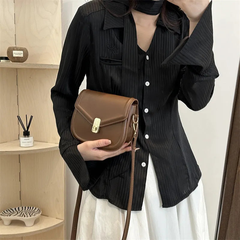 Soft textured PU shoulder messenger bag in horizontal square clamshell design.