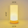 Nordic solid wood USB table lamp in a white geometric shape on a wooden surface.