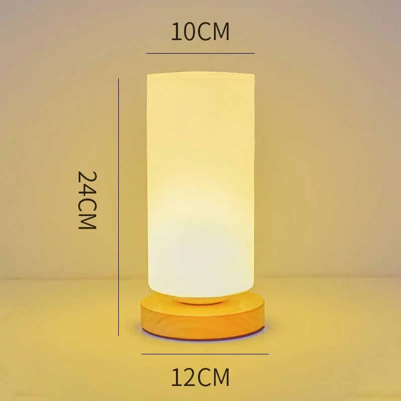 Nordic solid wood USB table lamp in a white geometric shape on a wooden surface.