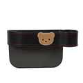 Car seat gap storage organiser with cartoon bear design hanging between vehicle seats