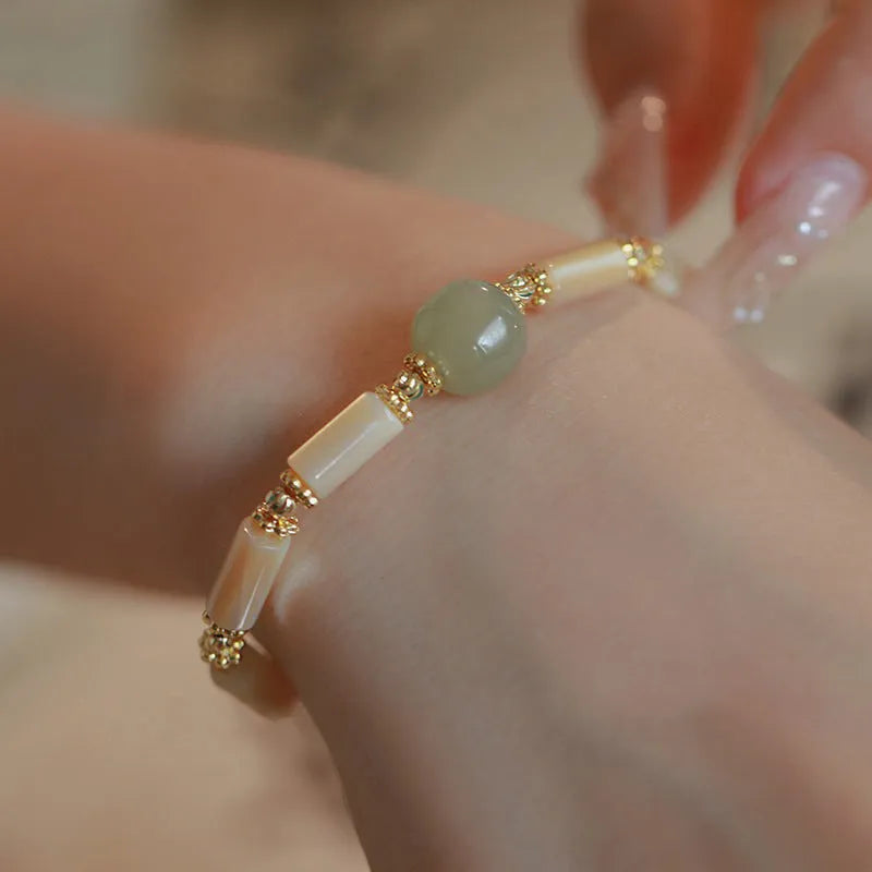 Hetian Jade white lip shell bead bracelet with round beads on wrist