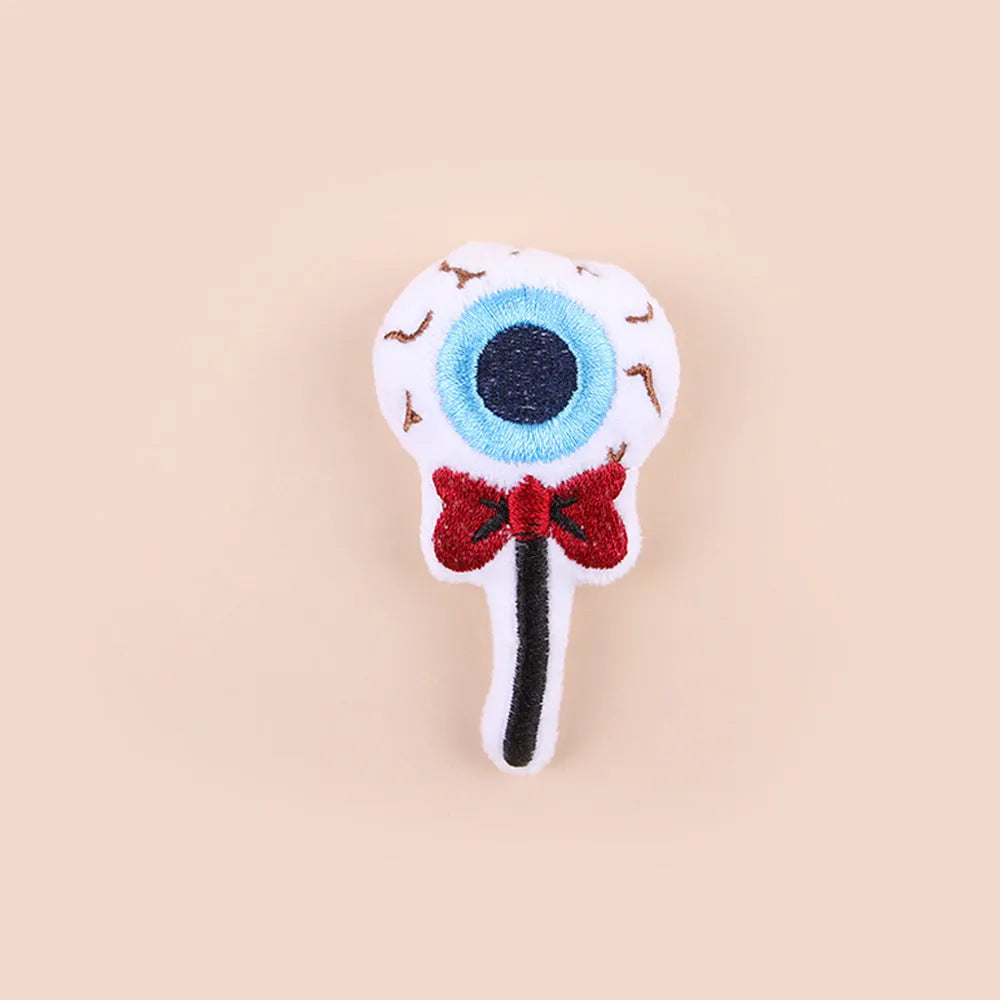 Handheld plush cat teaser toy with candy design on small wand for interactive play