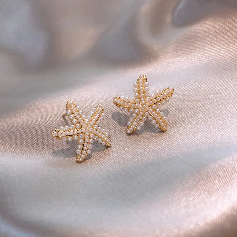 Korean style gold pineapple starfish pearl earrings made from electroplated alloy with inlaid stones.