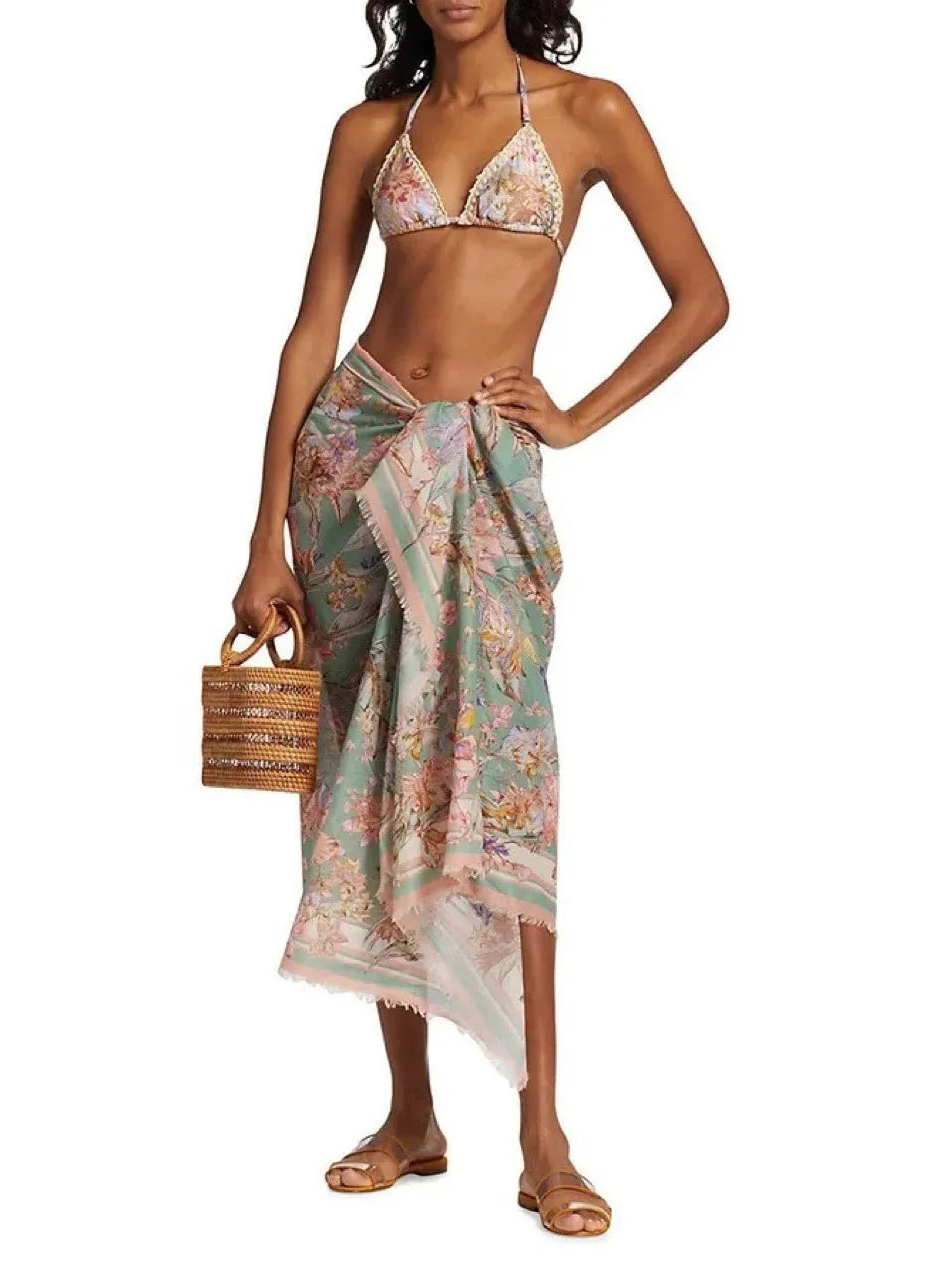 Women's creamy white floral bikini set with skirt cover-up on beach