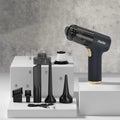 Black wireless handheld car vacuum cleaner with multiple nozzle attachments on a black background