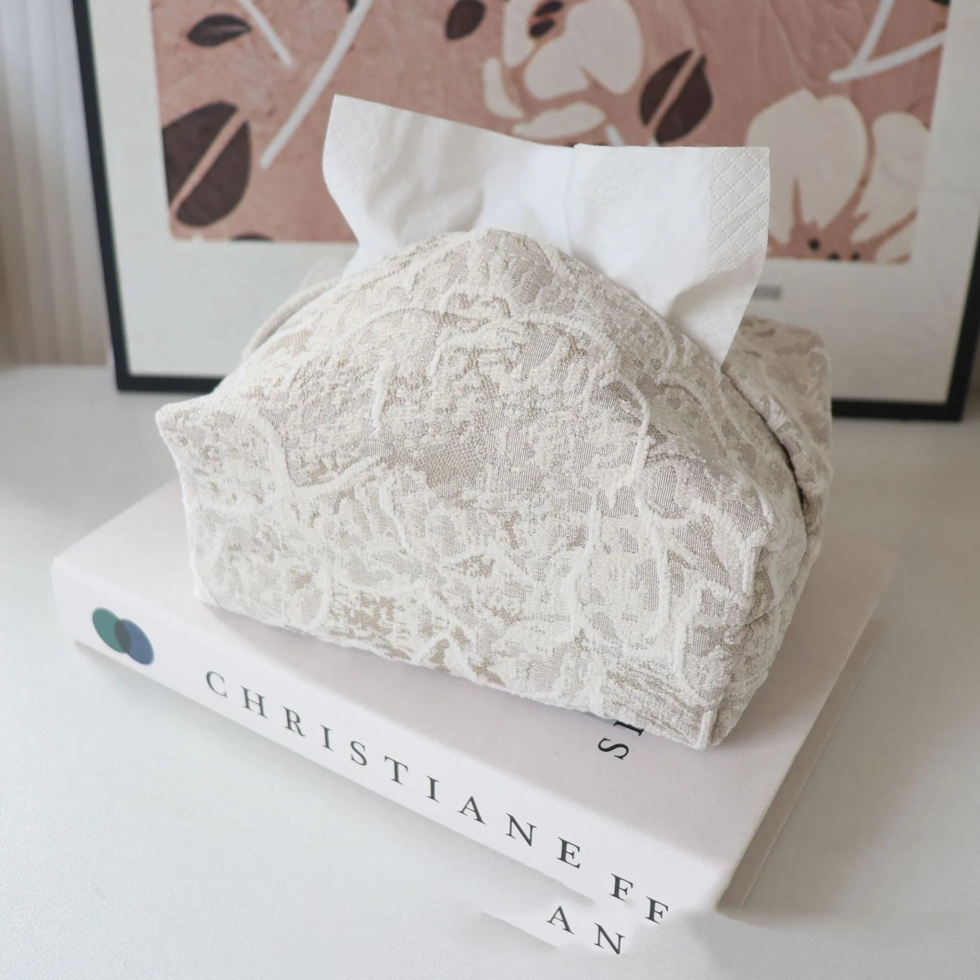 Handmade beige rose patterned cotton fabric tissue box cover on a wooden table.