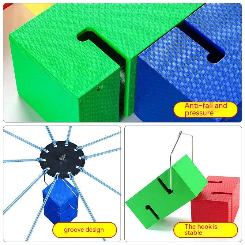 Set of coloured ABS plastic tower blocks with pull ropes and metal hook frame for outdoor team building games.