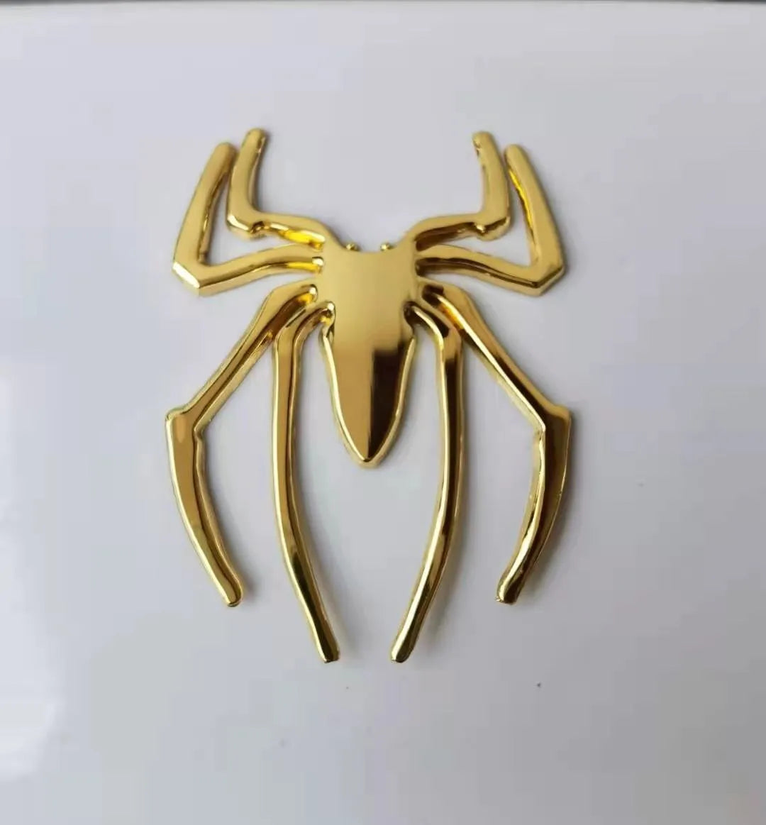 3D metallic spider bumper sticker in gold, silver, black, and red colour options.