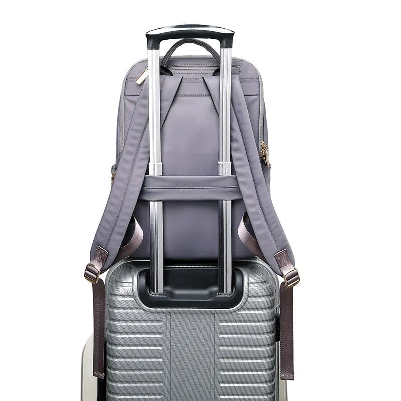 Oxford cloth women's backpack in black and purplish grey, showing large capacity and shoulder straps.