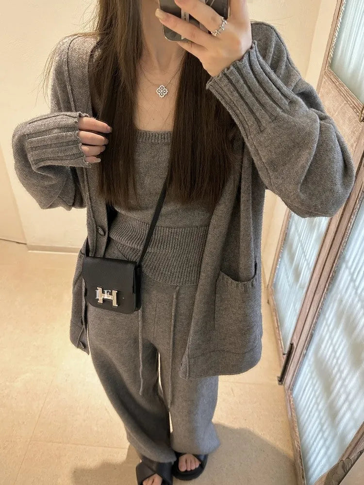 Women's loose fit knit cardigan, vest, and casual pants three-piece set in a solid colour.