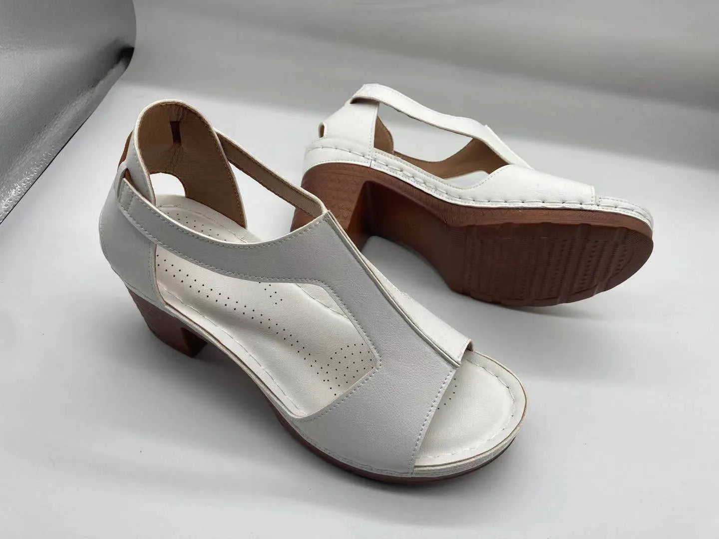 Women's peep toe wedge sandals with a buckle strap, shown in a light brown colour on a white background.