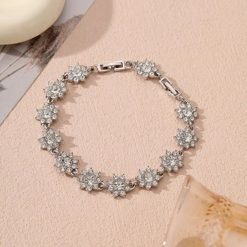Electroplated zinc alloy flower bracelet in a choice of gold or silver finishes with coloured gemstone designs.