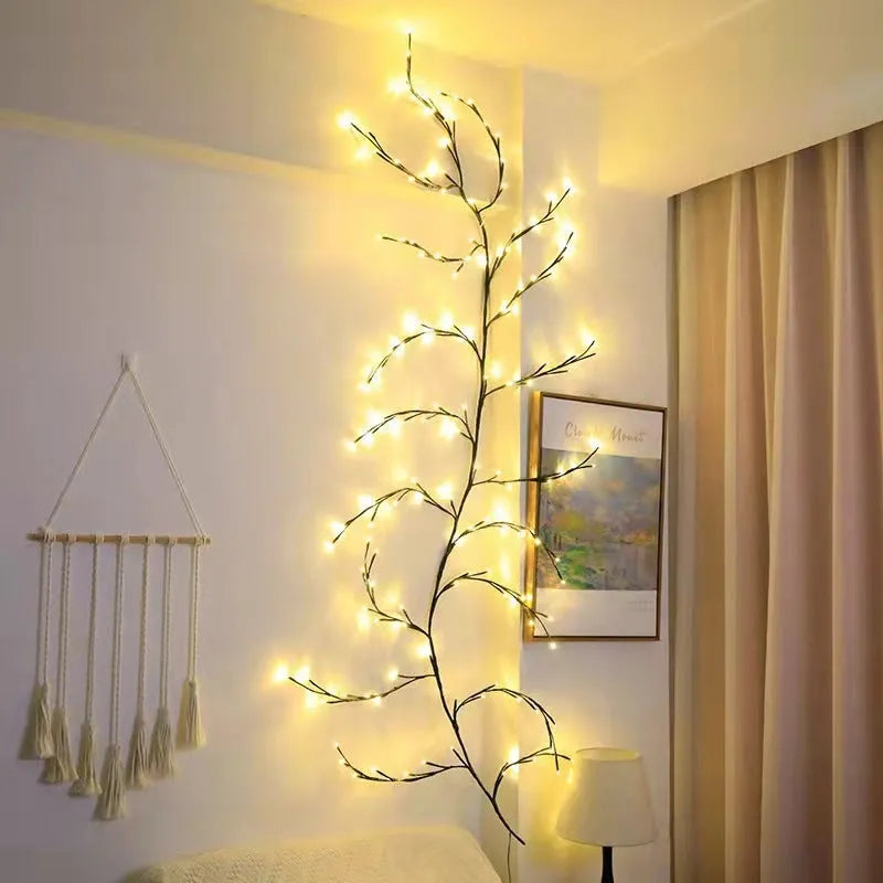 Flexible LED willow vine garland with warm white lights on birch-textured branches for wall and party decor.