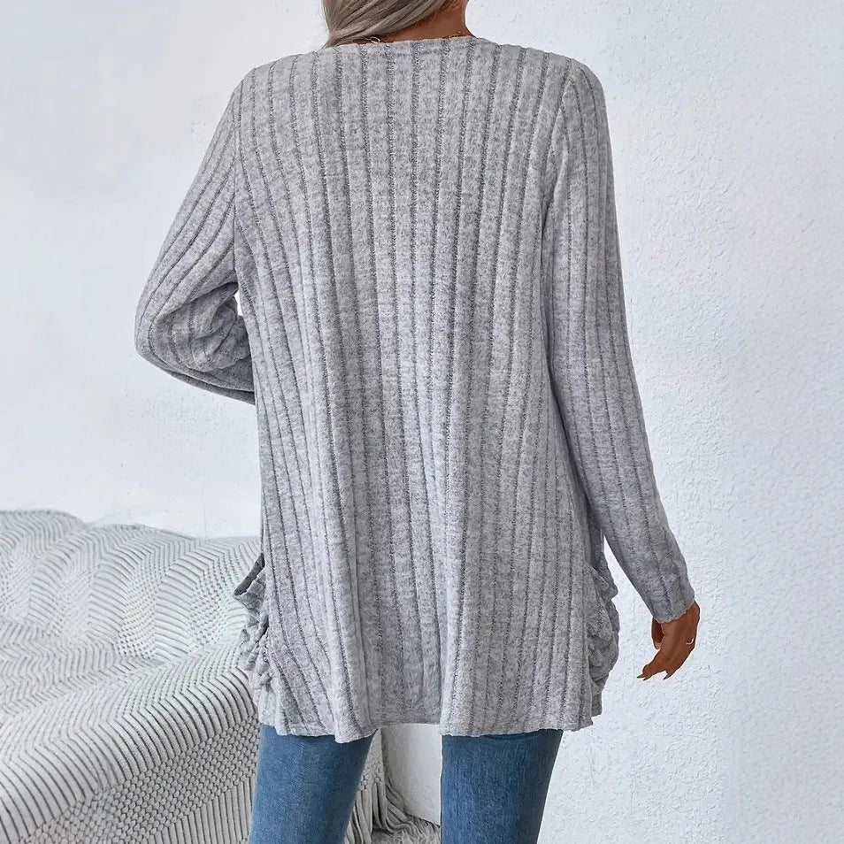 Grandma Grey loose fit long sleeve cardigan with two front pockets, shown on a hanger.