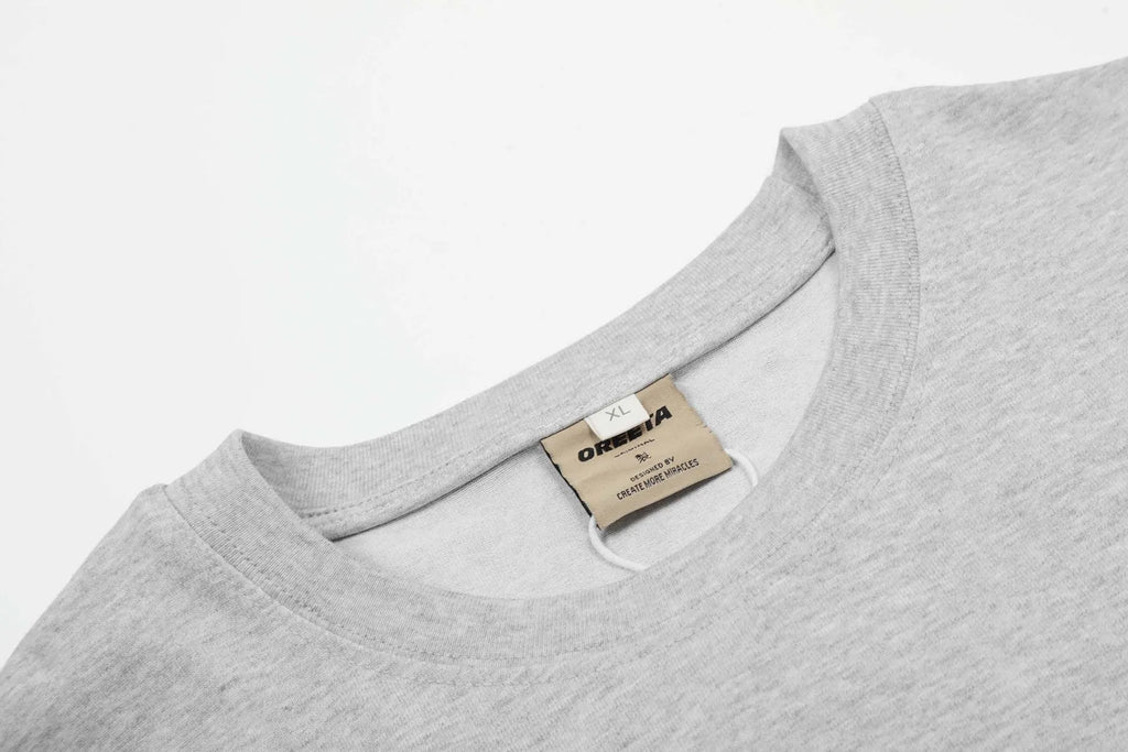 A man's loose-fit black cotton pullover T-shirt with long sleeves in a casual retro style.