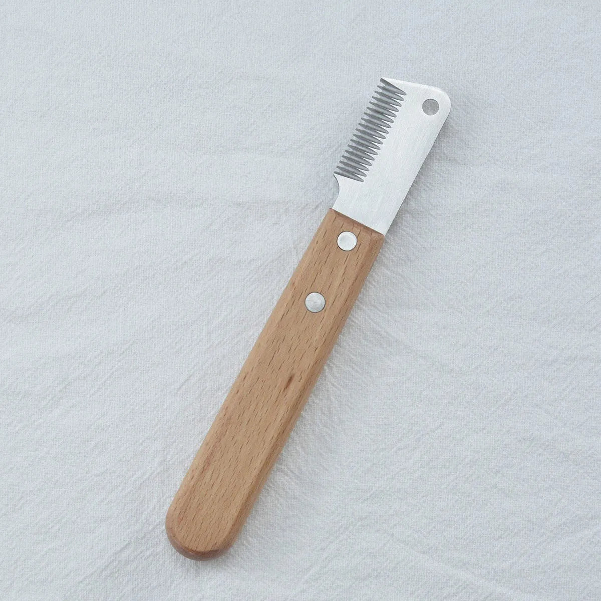 Pet grooming comb with wood handle and metal teeth for removing floating hair from dogs and cats