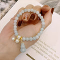 Chinese style jade bracelet with gourd design on woman's wrist