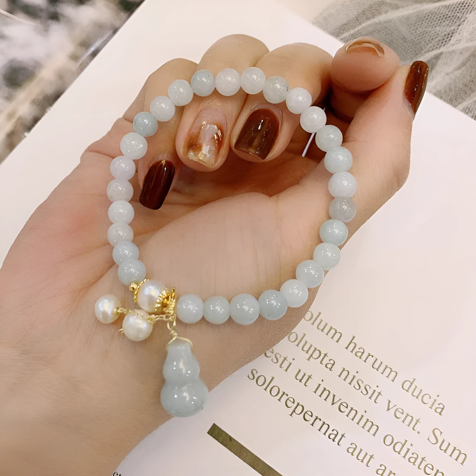 Chinese style jade bracelet with gourd design on woman's wrist