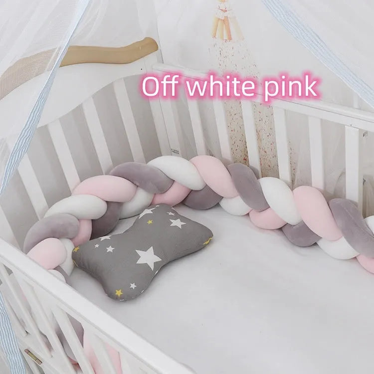 Bendable braid-knot baby crib bumper in spandex velvet, shown in a light grey colour wrapped around a cot.