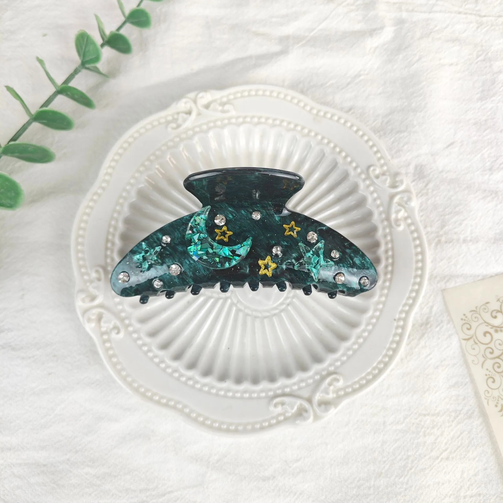 Oversized women's barrette with a starry sky design in blue, made from cellulose acetate sheet.
