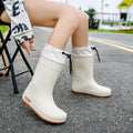 Women's PVC rain boots in apricot colour with non-slip soles and waterproof mouth detailing