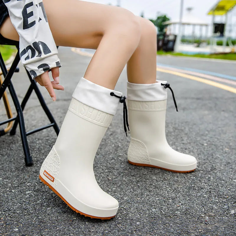 Women's PVC rain boots in apricot colour with non-slip soles and waterproof mouth detailing