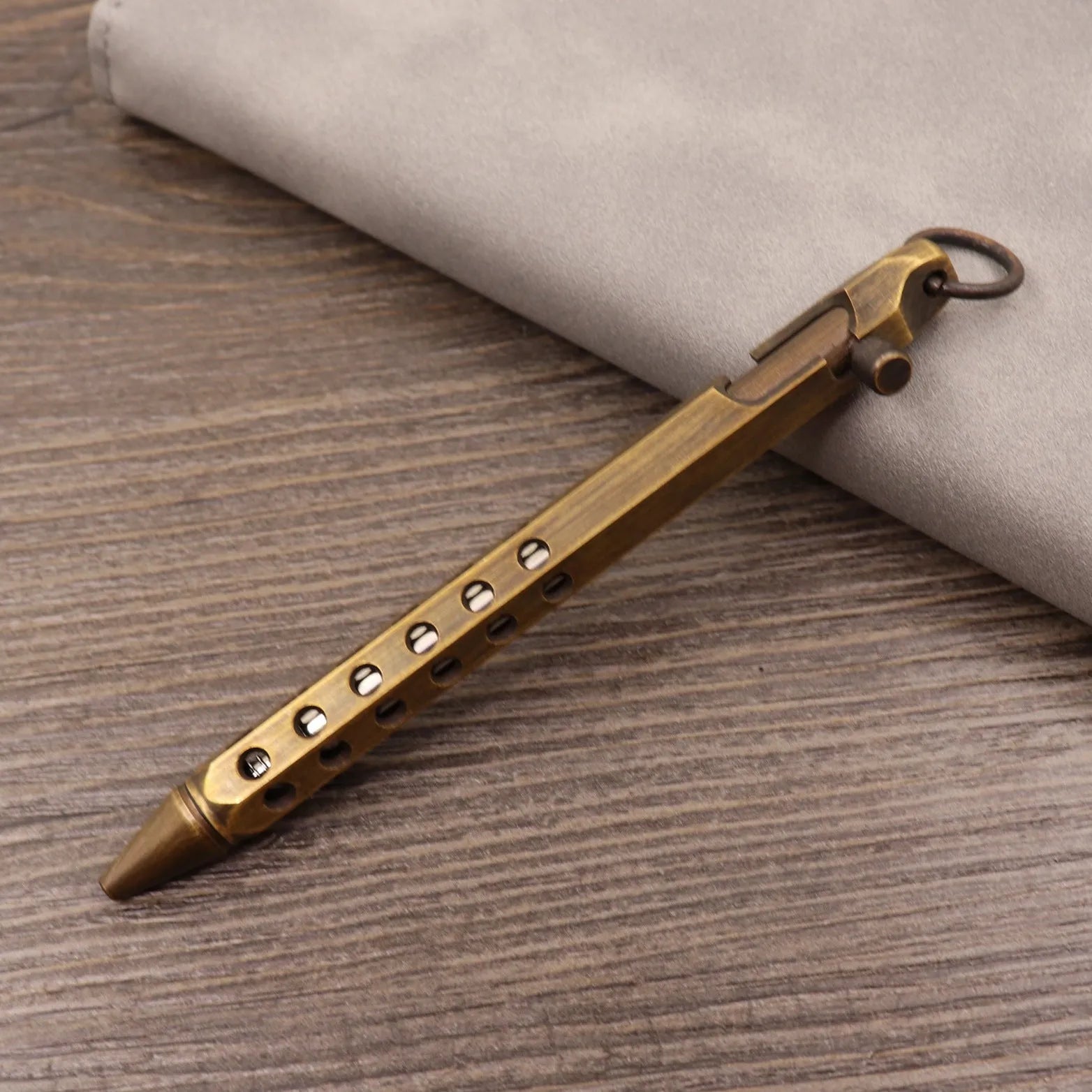 Brass tactical pen with bolt-action mechanism and retro brushed finish